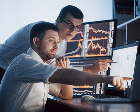 Two men reviewing investment data